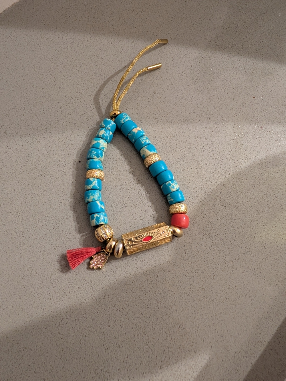 Turquoise Beaded Gold Accent Bracelet with Coral and Tassel